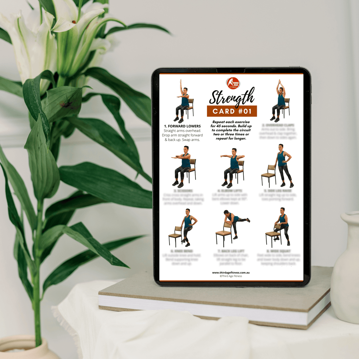 Tablet displaying a strength training card with exercise illustrations on a table with a plant in the background